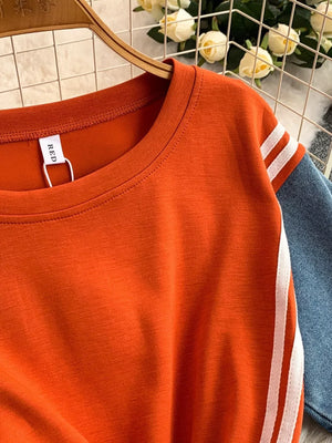 Orange red casual dress with white stripe detail on sleeves and denim accents.