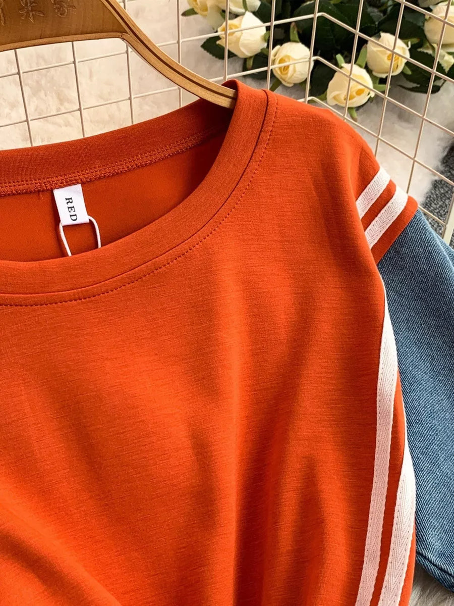 Orange red casual dress with white stripe detail on sleeves and denim accents.