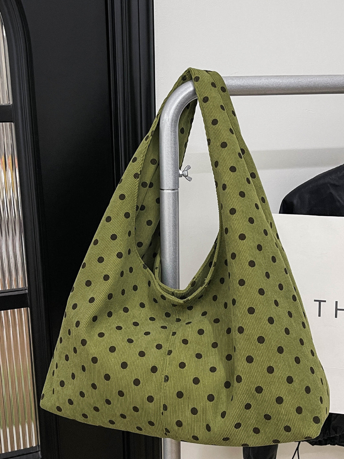 olive green handbag featuring polka-dot print and polka dot