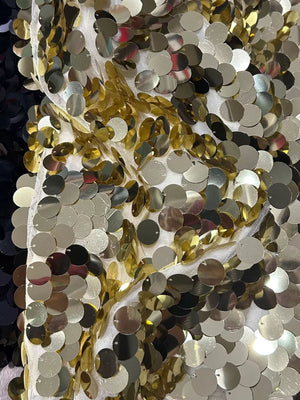 Women's mini skirt with gold and silver sequins on white mesh fabric.