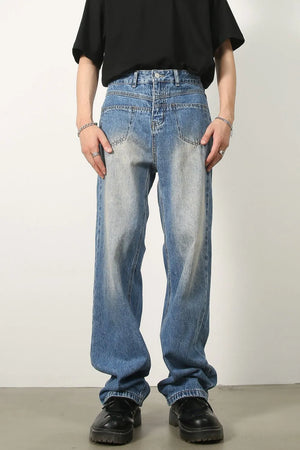 Vintage wash baggy denim jeans in medium blue with a relaxed fit and faded details.