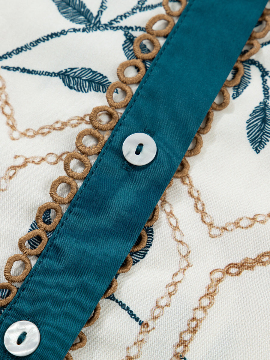 Cotton polo collar mini dress with chain and leaf print, button front, and decorative trim.