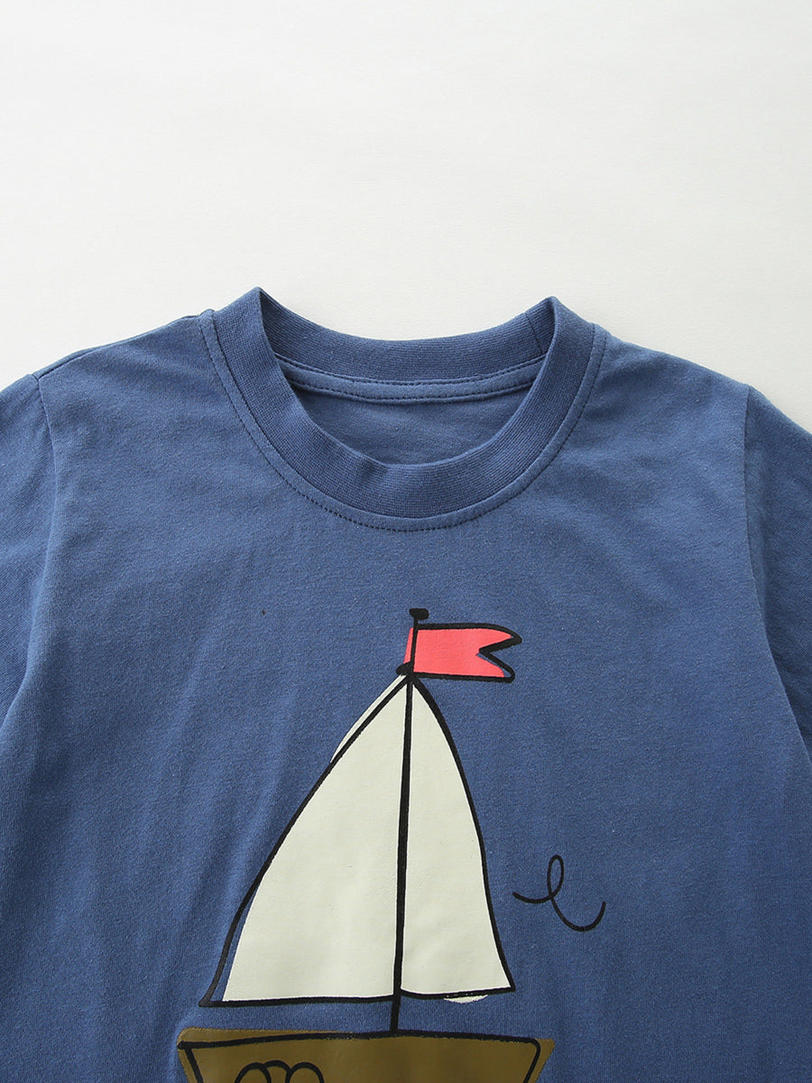 Blue cotton tee with sailboat graphic and red flag detail.