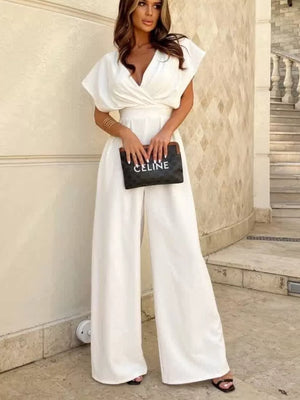 White surplice wide-leg romper with V-neck and dolman sleeves.