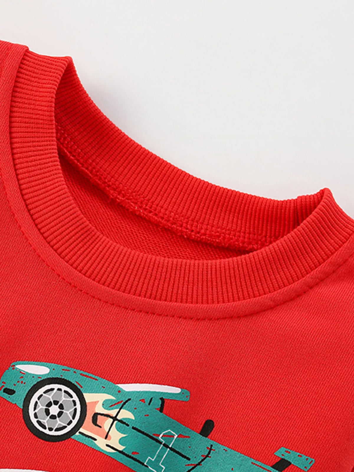 Red crew neck sweatshirt for kids with a car print and comfortable cotton fabric.