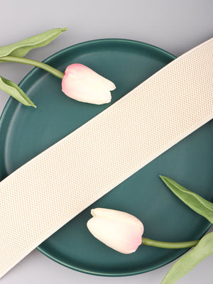 Cream elastic belt with textured weave and gold hardware detail