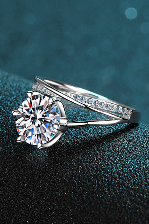 Silver bypass ring with large solitaire diamond and pavé band.