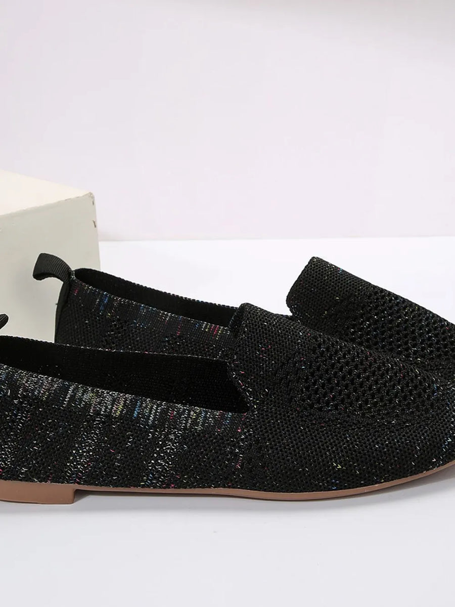 Knit ballet flats in black with subtle multicolor flecks and a pull tab.