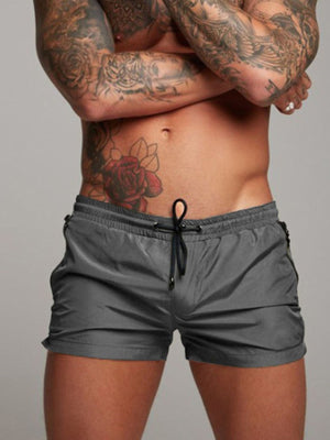 Grey drawstring swim shorts with side zippers
