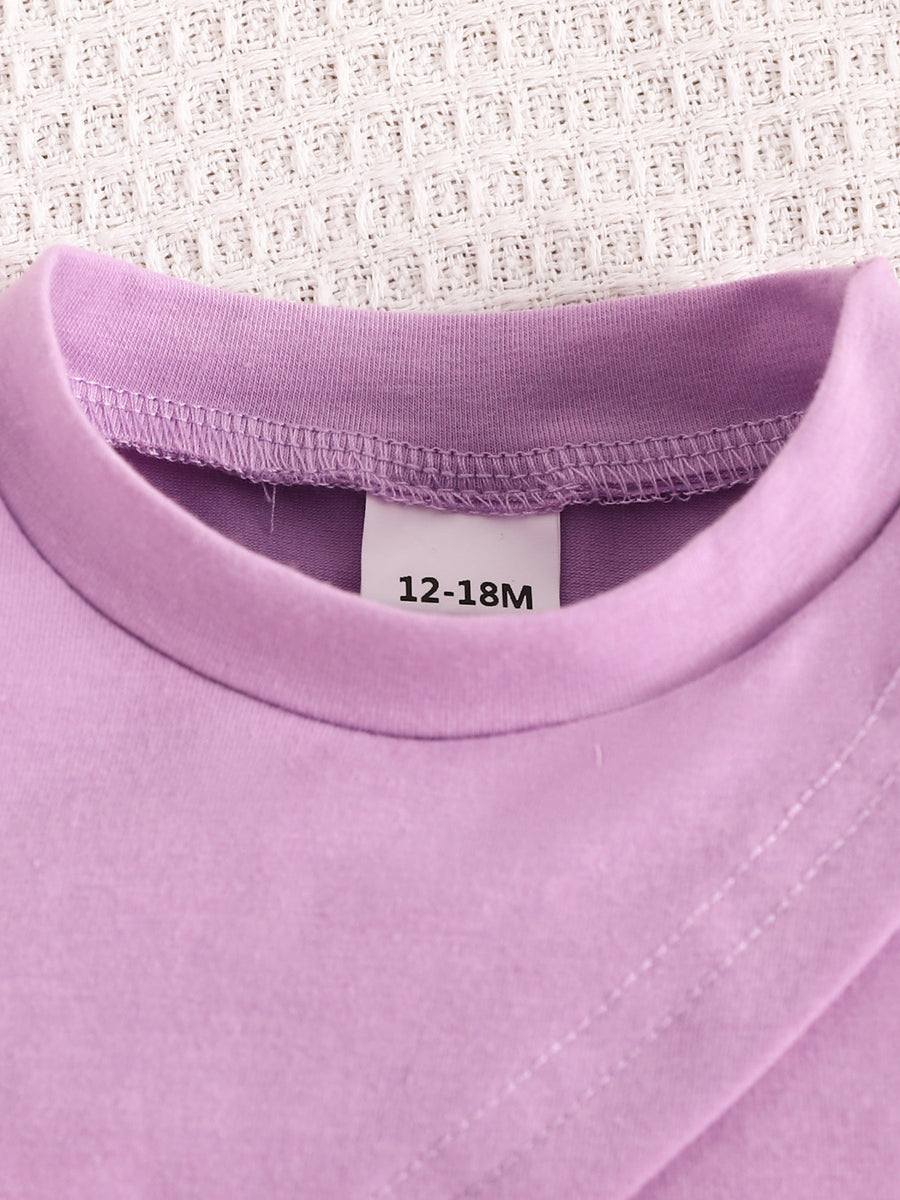Violet toddler crop top with a crew neck and size tag 12-18M.