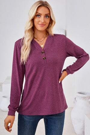 Henley button-down knit top in a deep plum color with a V-neck and two dark buttons.