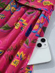 Floral midi dress in cerise cotton blend with ruffled sleeves and belted waist.