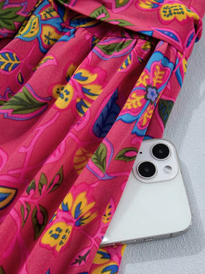 Floral midi dress in cerise cotton blend with ruffled sleeves and belted waist.