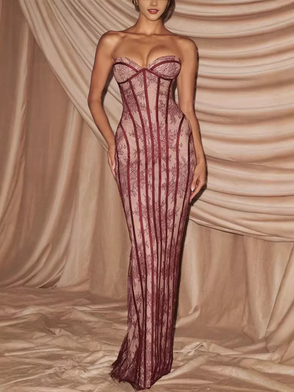Burgundy lace sweetheart neckline maxi dress with corset detail and sheer skirt.