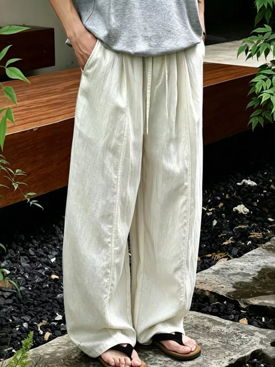 Flax wide-leg sweatpants with drawstring waist and pockets, styled casually.