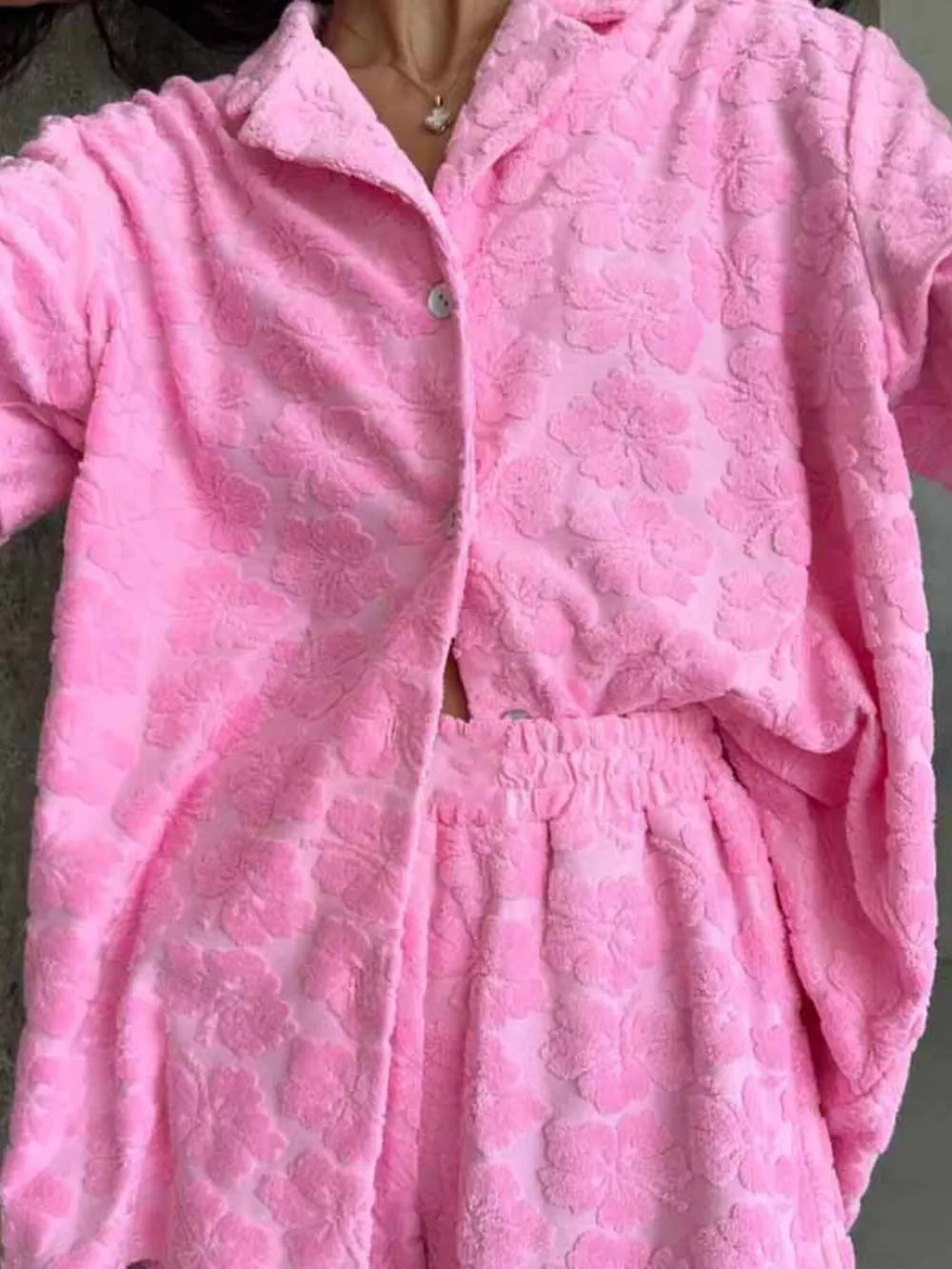 Pink textured floral button-up shirt and shorts set with elastic waist shorts.