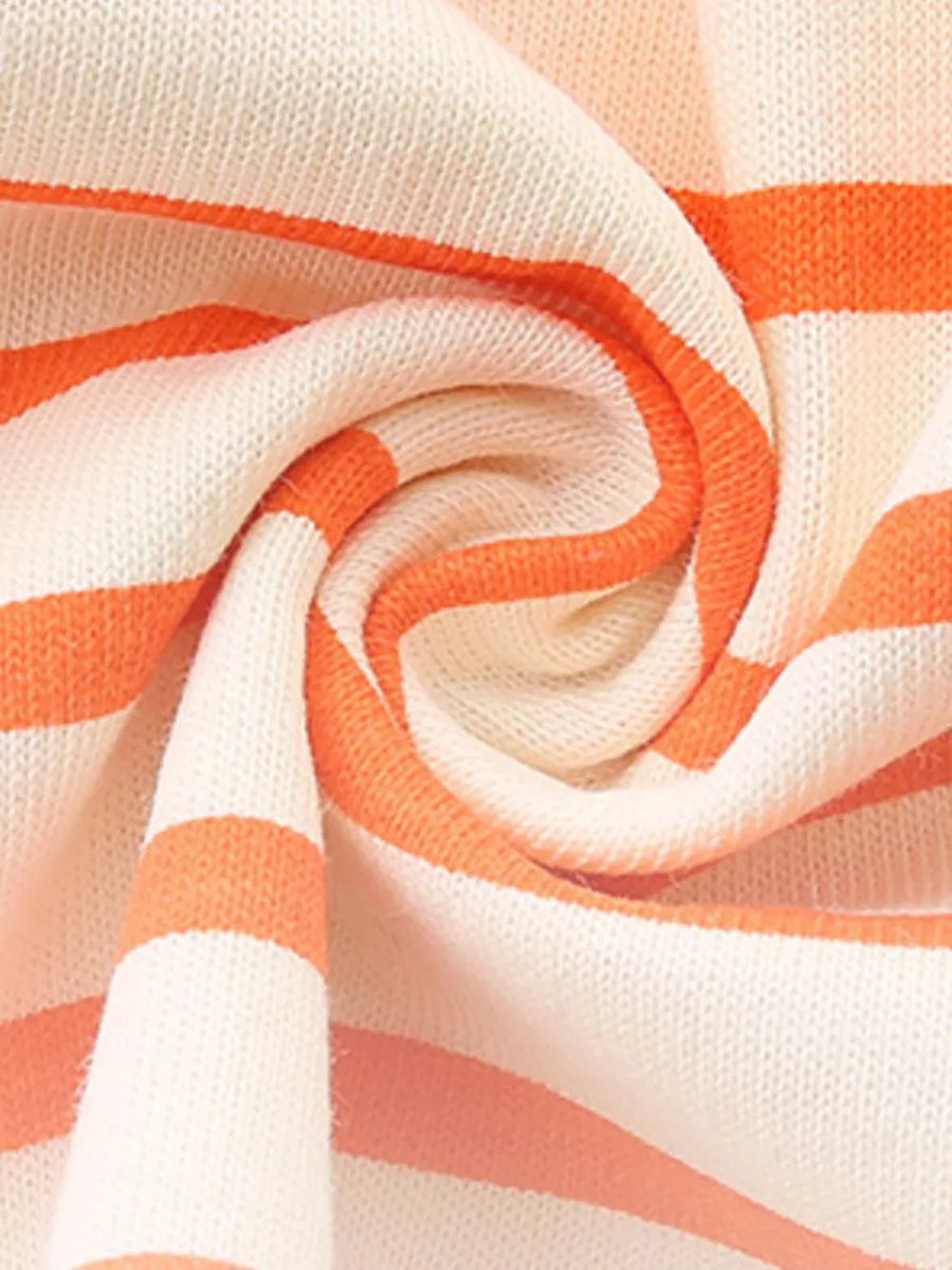Toddler striped cotton dress in cream and orange with ruffled details.