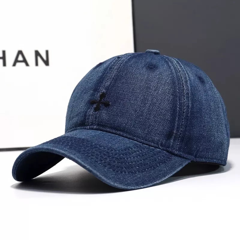 Dark blue denim baseball hat with black embroidered detail