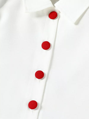 White baby top with red button detail and collar