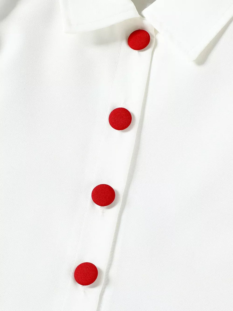 White baby top with red button detail and collar