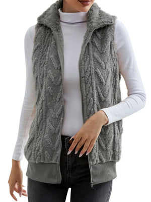 Dark gray faux fur zip-up vest with chevron texture and ribbed hem