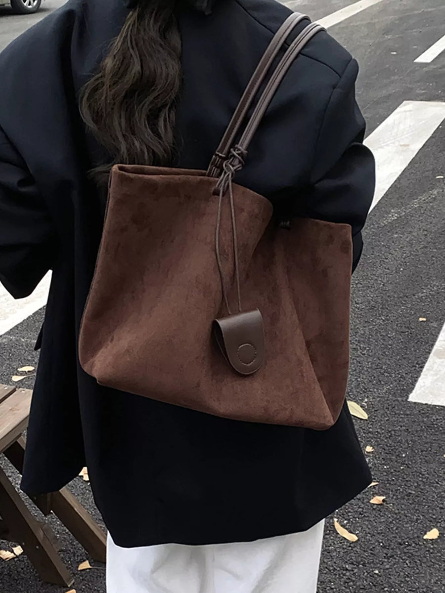 Large caramel brown suede tote shopper bag with leather tab detail.