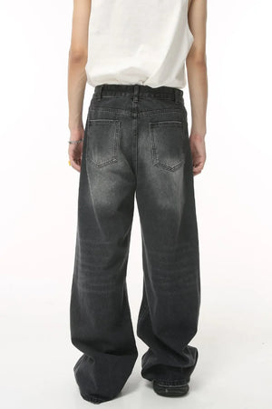 Oversized wash denim trousers in charcoal grey with a baggy fit and classic five-pocket styling.