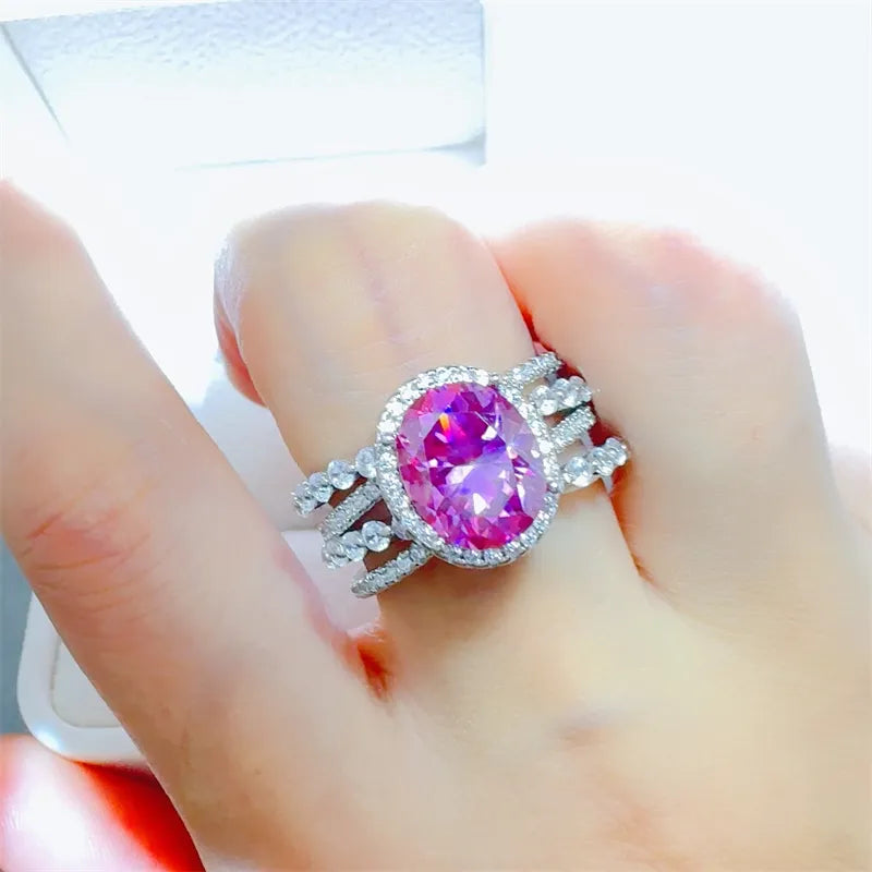 Radiant Halo & Stacked Gem Ring in silver with a large oval pink center stone and clear accent stones.