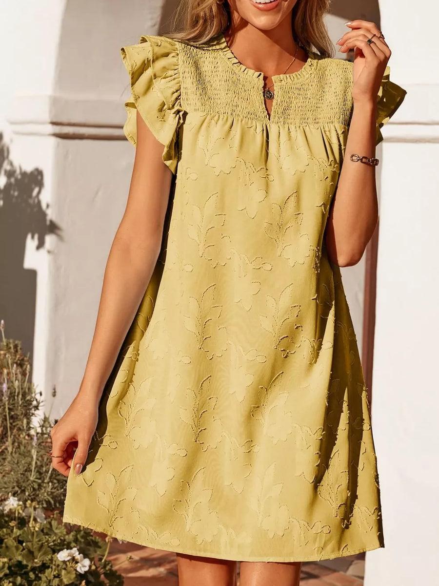 Apricot floral embossed mini dress with smocked bodice and ruffled cap sleeves.