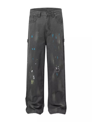 Distressed charcoal wide-leg sweatpants with paint splatter detail and a ripped knee.