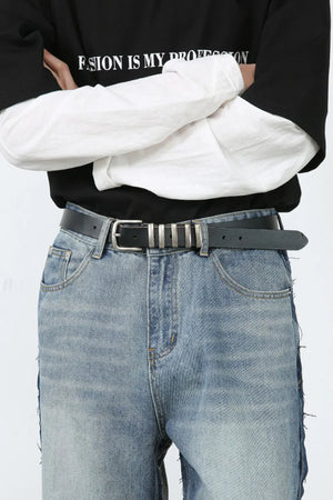 Paneled wide-leg denim trousers in medium wash with distressed hem detail.