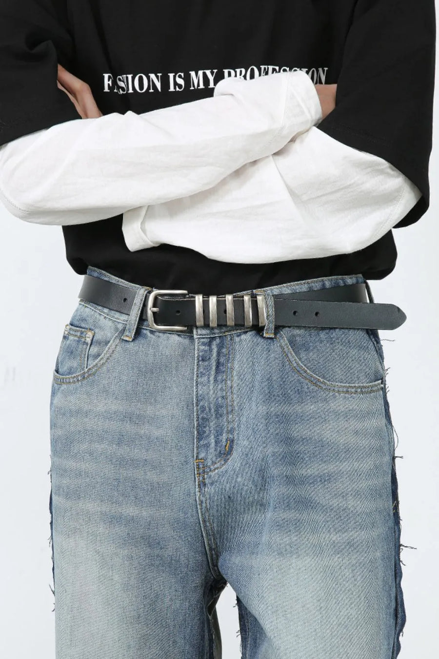 Paneled wide-leg denim trousers in medium wash with distressed hem detail.