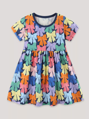 Toddler a-line dress with colorful bow print, short sleeves, and round neckline.