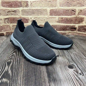 Dark gray knit slip-on sneakers with platform sole and sock-fit upper.