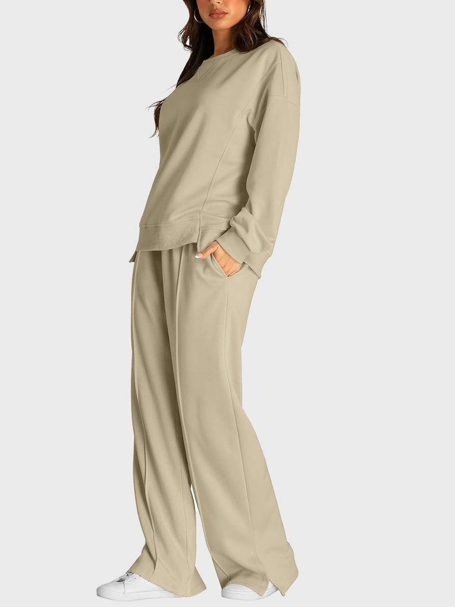 Tan loungewear set with crewneck sweatshirt and slit-front wide-leg trousers.