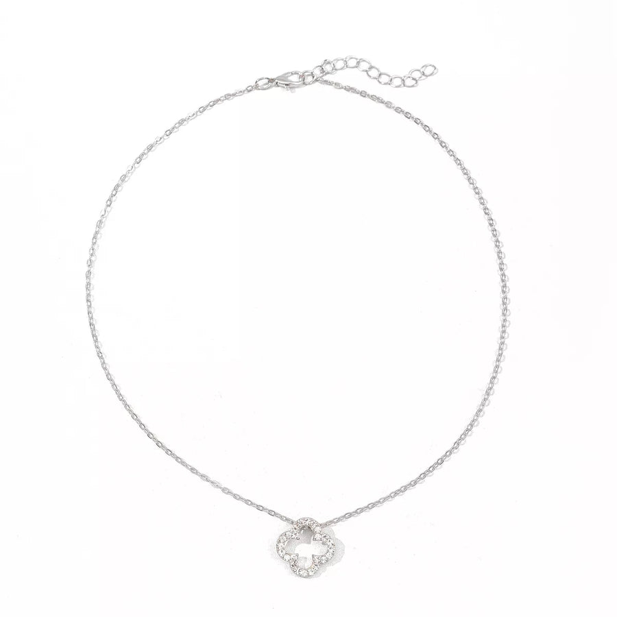 Silver clover pendant necklace with clear stones on a delicate chain.