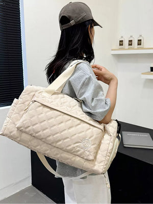 Diamond-quilted travel bag in off-white with versatile straps and front pocket detail.
