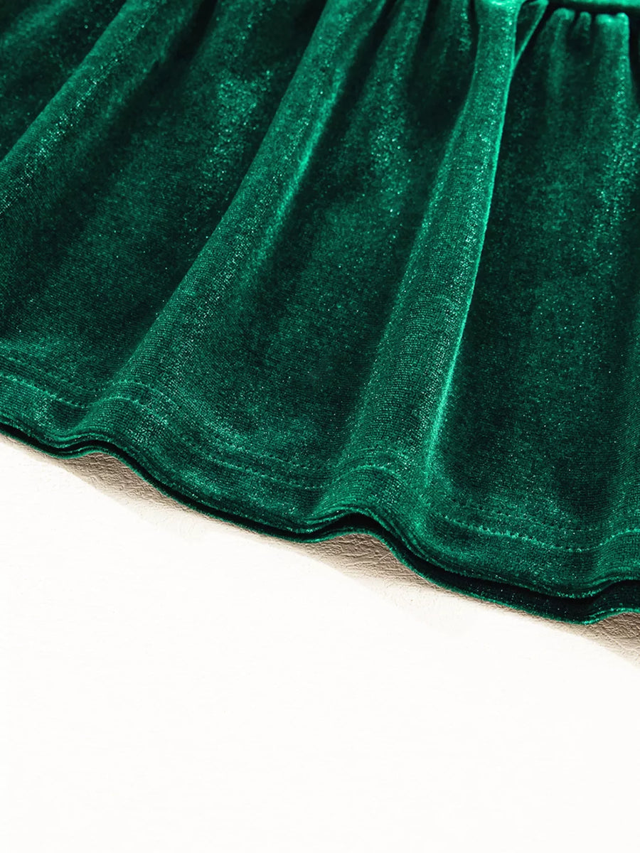 Dark green velvet tiered mini dress hem detail with subtle sparkle