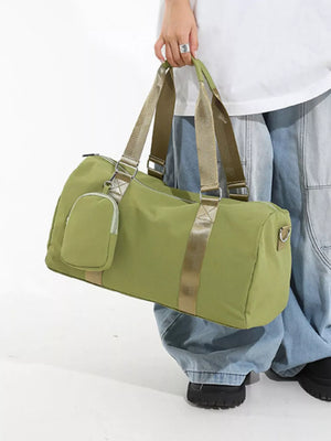 Green duffle bag with detachable pouch and gold strap detail.