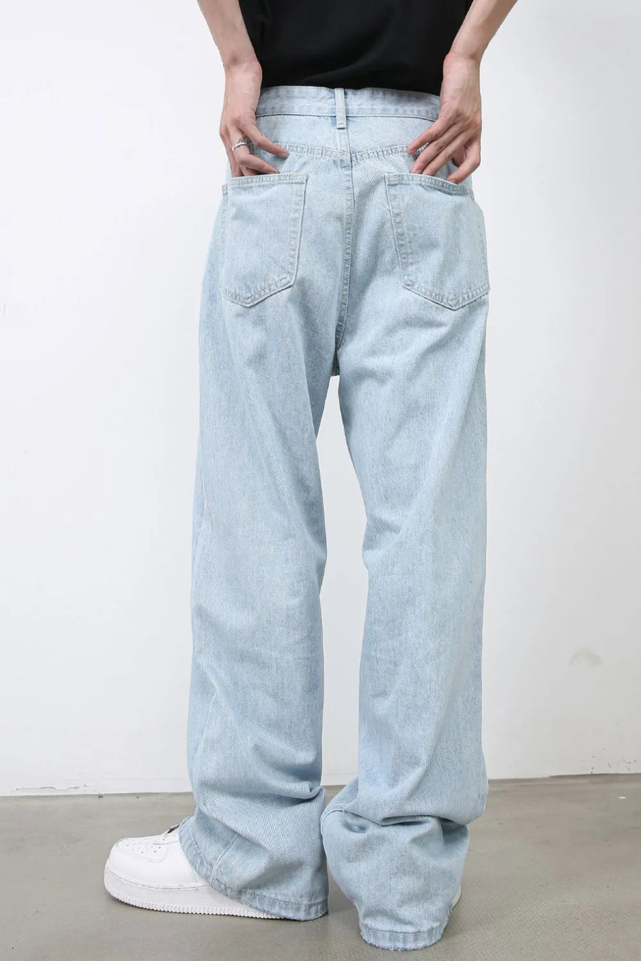Baggy light blue denim palazzo jeans with back pockets and a buttoned waist.