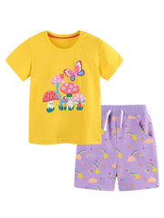 Yellow cotton t-shirt with mushroom & butterfly print and purple shorts with rainbow & star print.