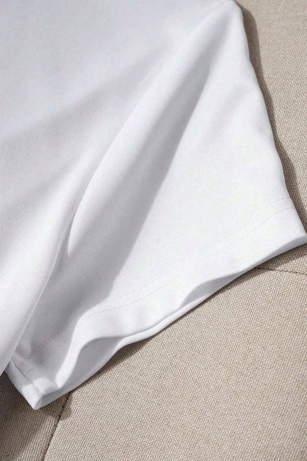 White t-shirt sleeve detail with visible stitching