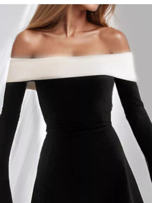 Black off-shoulder dress with flare sleeves and an eggshell neckline detail.