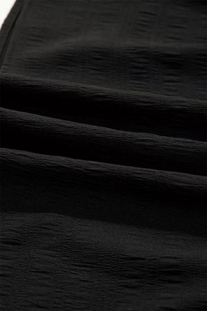 Black crinkled fabric with a textured finish