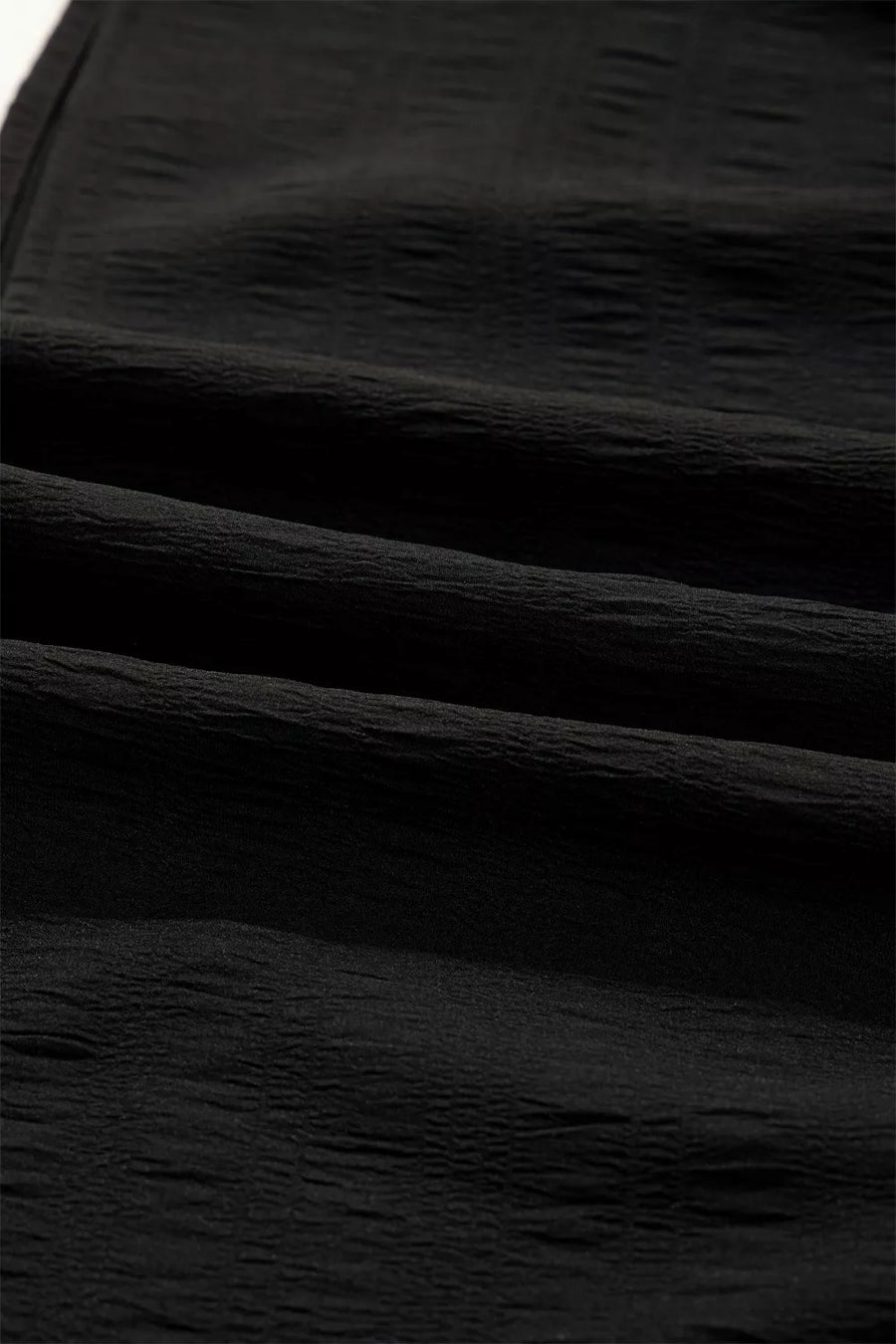 Black crinkled fabric with a textured finish
