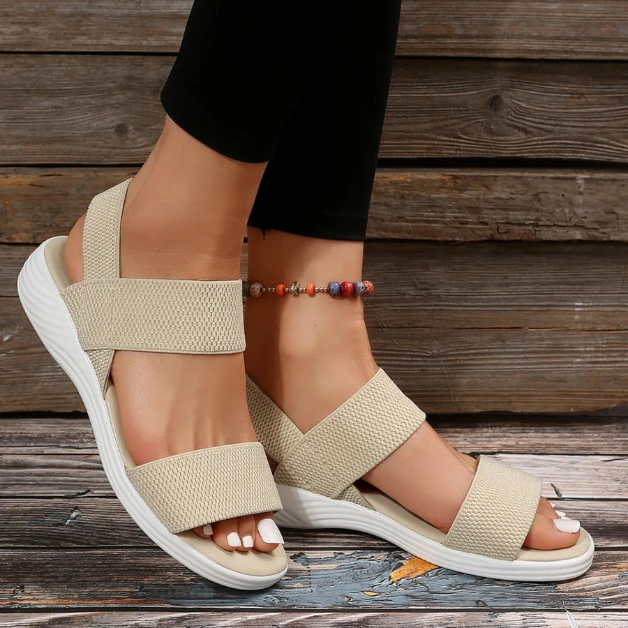 Sporty knit strap sandals in cream with white soles and a beaded anklet.