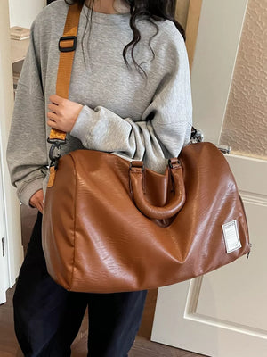 Brown pu leather travel bag with adjustable strap and top handles