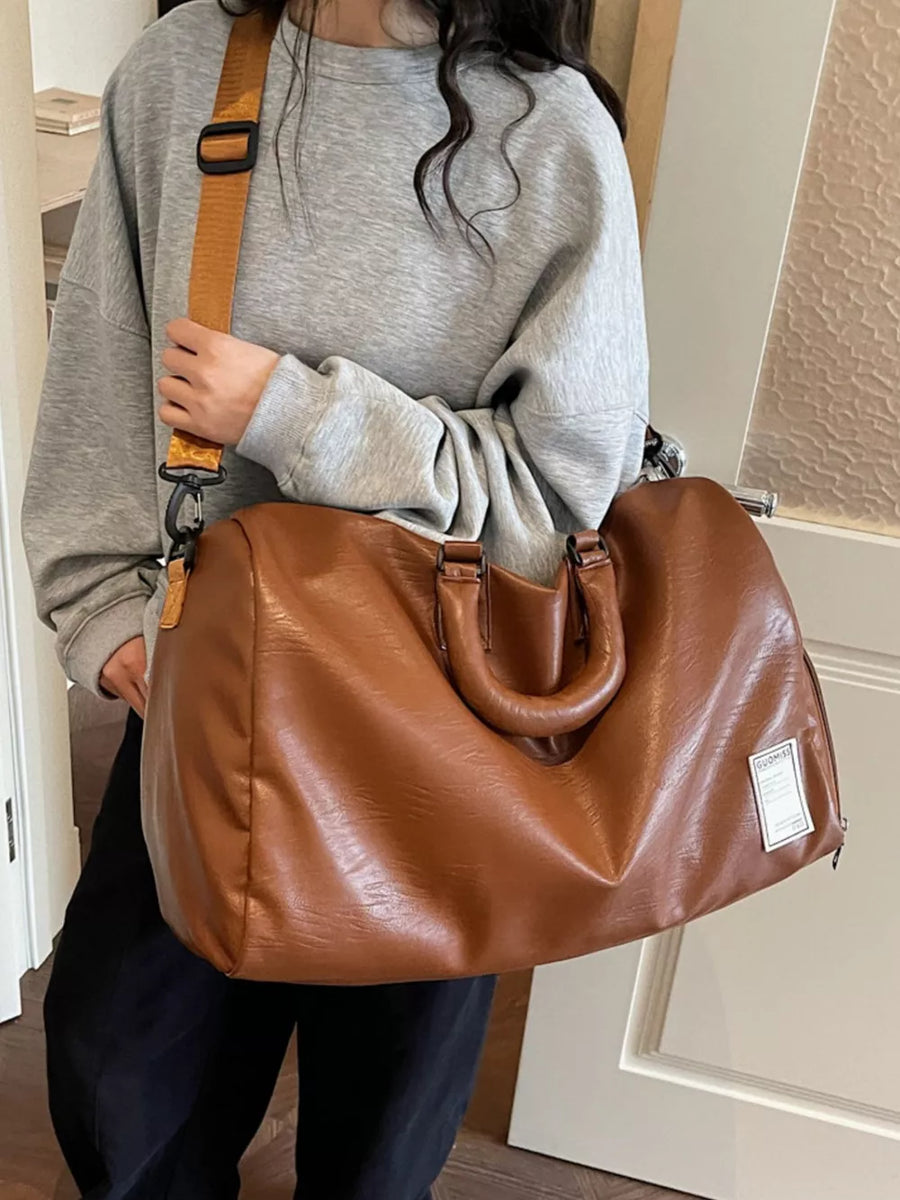 Brown pu leather travel bag with adjustable strap and top handles