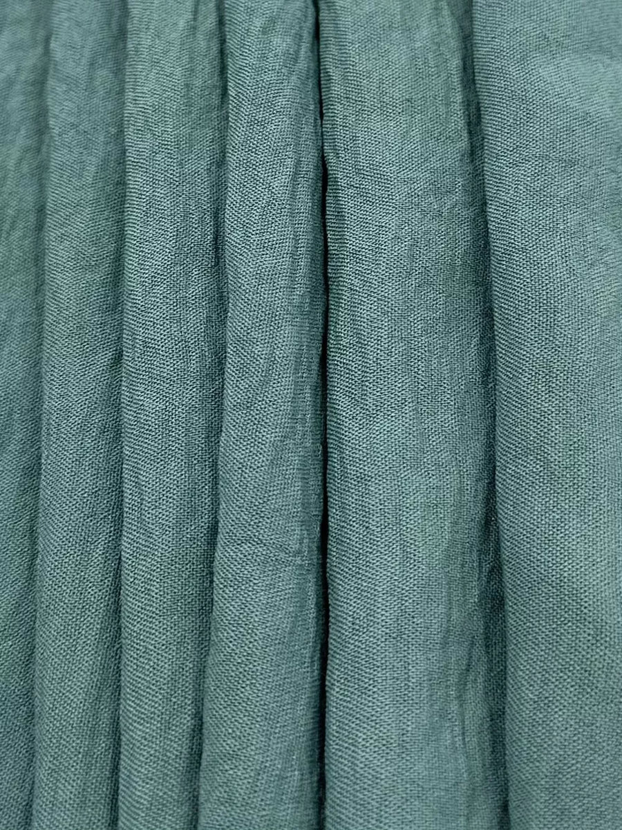 Turquoise linen blend fabric with vertical pleats and visible texture.
