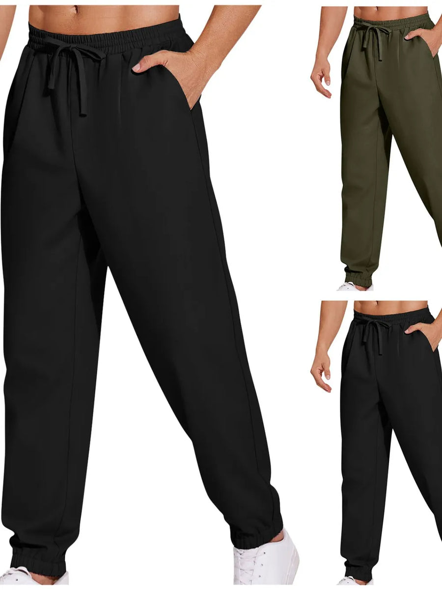 Relaxed-fit cuffed trousers in black and army green with drawstring waist and pockets.